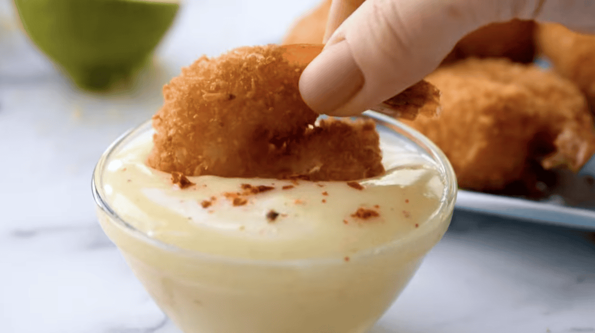 a coconut shrimp dipped in pina colada sauce.