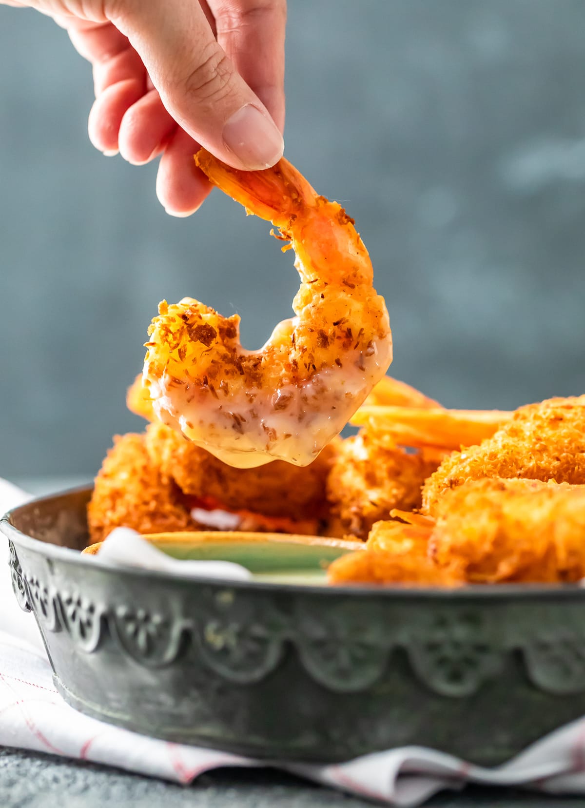 a coconut shrimp dipped in pina colada sauce.