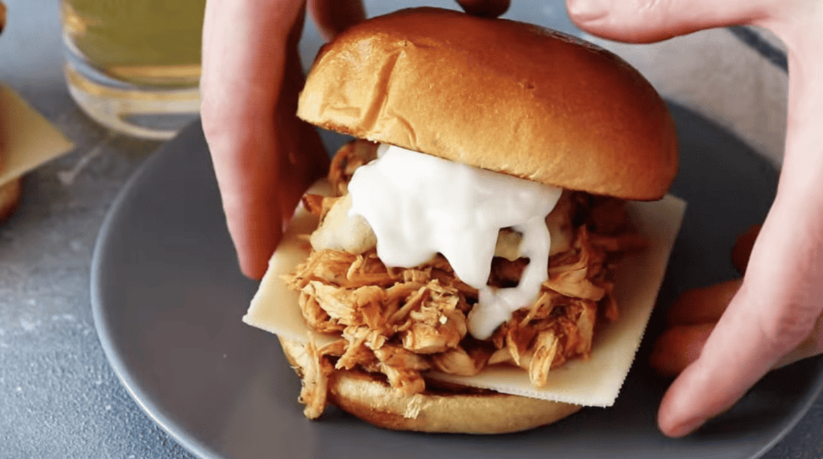 a crockpot buffalo chicken sandwich on a plate.