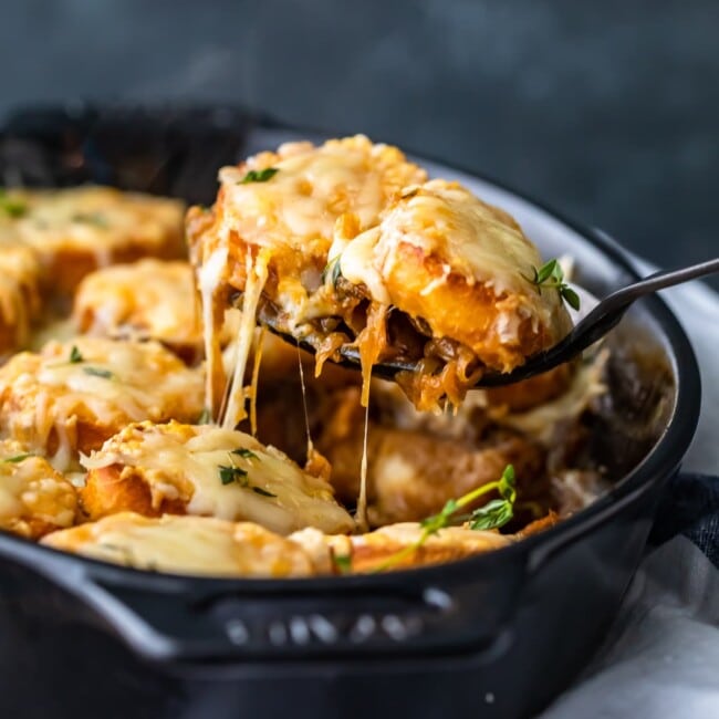 Cheesy potato casserole with onion in a skillet.