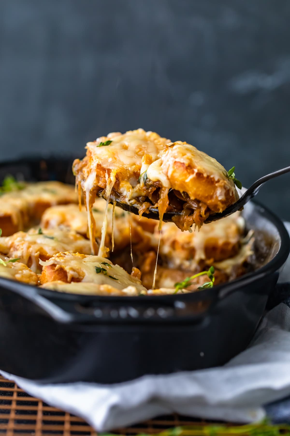 casserole dish filled with french onion soup casserole, viewed from the side