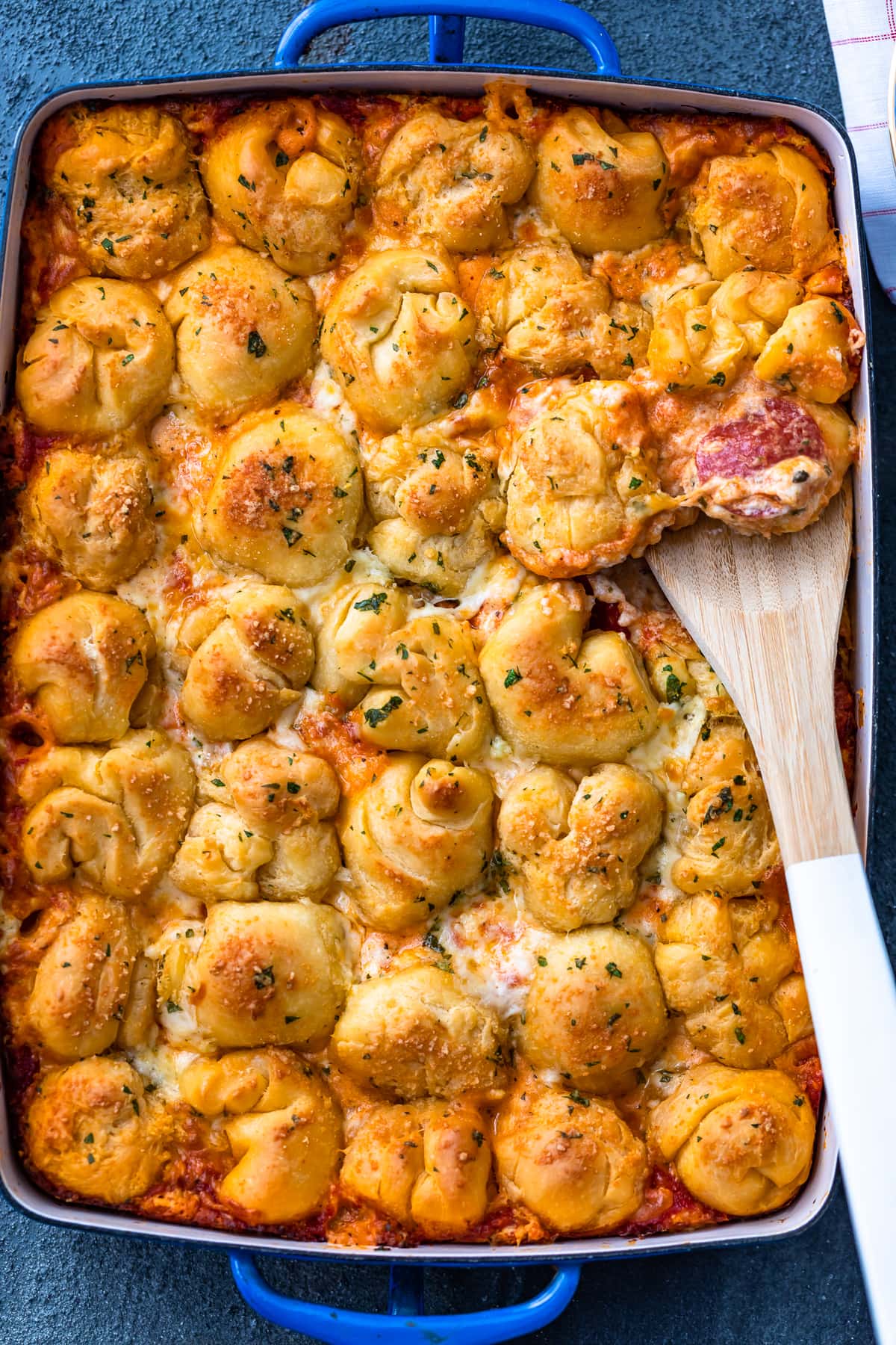 pizza casserole topped with balls of garlic bread pizza dough