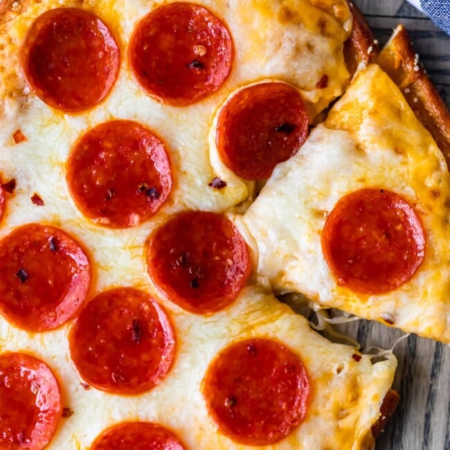 Soft Pretzel Crust Pizza with Cheese Sauce is the ULTIMATE easy Cheesy Pizza Recipe! This pizza is a Little Caesar's Copycat Recipe, modeled after their famous Pretzel Crust Pizza Recipe with cheese sauce instead of marinara! We are obsessed!