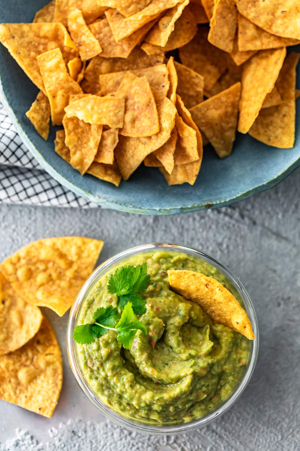 bowl of tortilla chips next to a bowl of dip