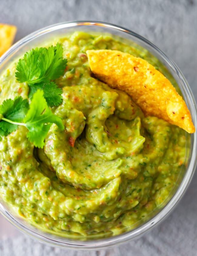 Easy Guacamole Recipe...I've never heard three words sound more beautiful! This simple and delicious Food Processor Guacamole is filled with great ingredients, and only takes a few minutes to make. No chunks here, just smoooooth guac!