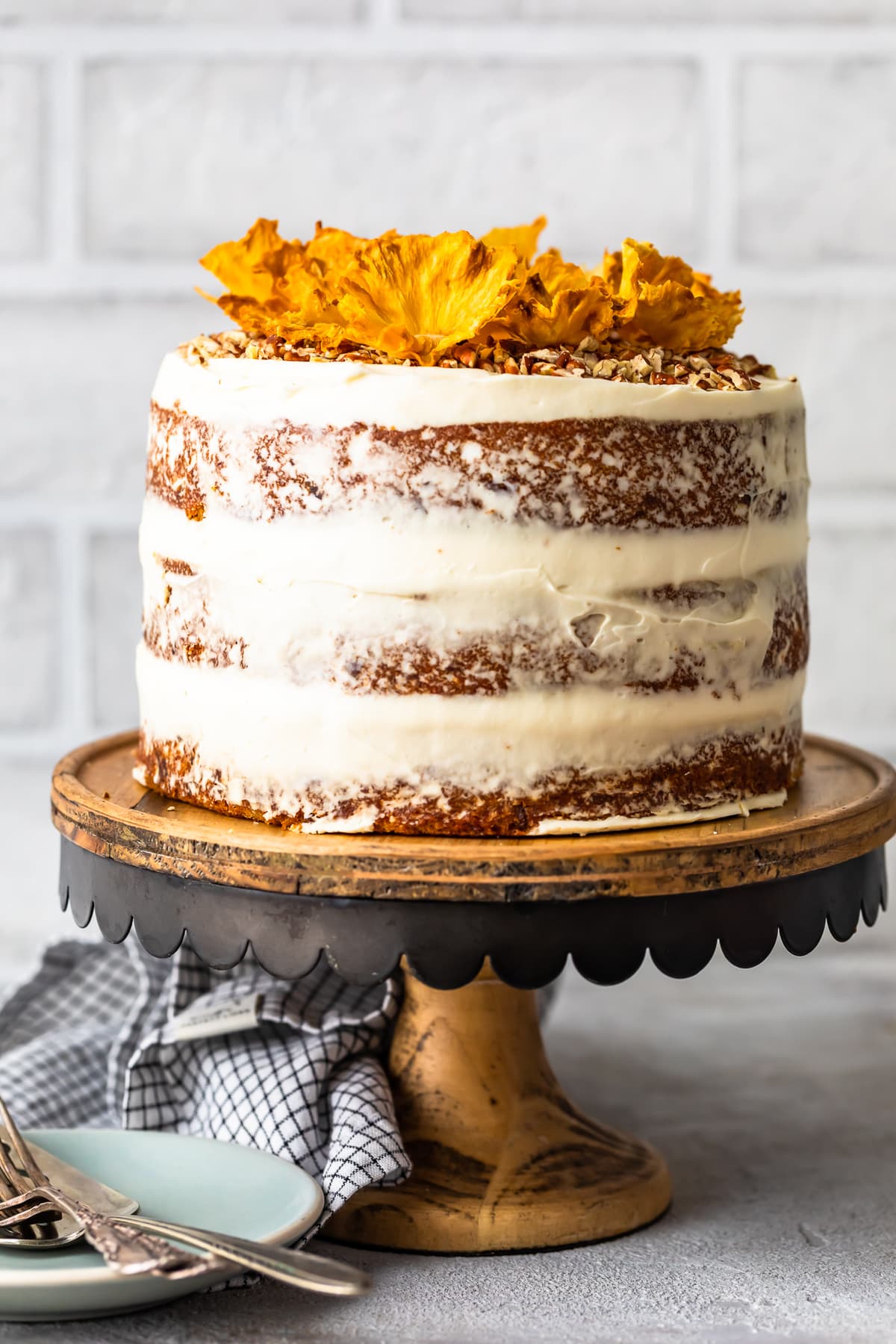 Hummingbird Cake on a cake stand with white brick background