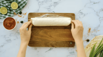 a rolled up tortilla wrapped in plastic wrap.