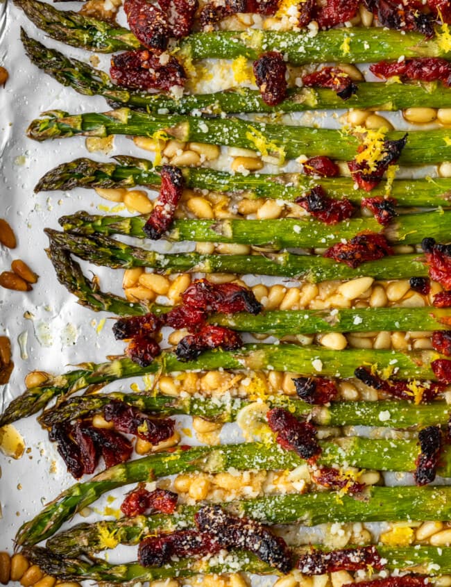 Oven Roasted Asparagus with sun dried tomatoes, pine nuts, garlic, and more is a delicious Mediterranean-inspired side dish fit for any occasion. This easy roasted asparagus recipe is quick to make yet filled with flavor! Add this asparagus side dish to your holiday meals, or just to your weeknight dinners. Either way, it's sure to be a hit!