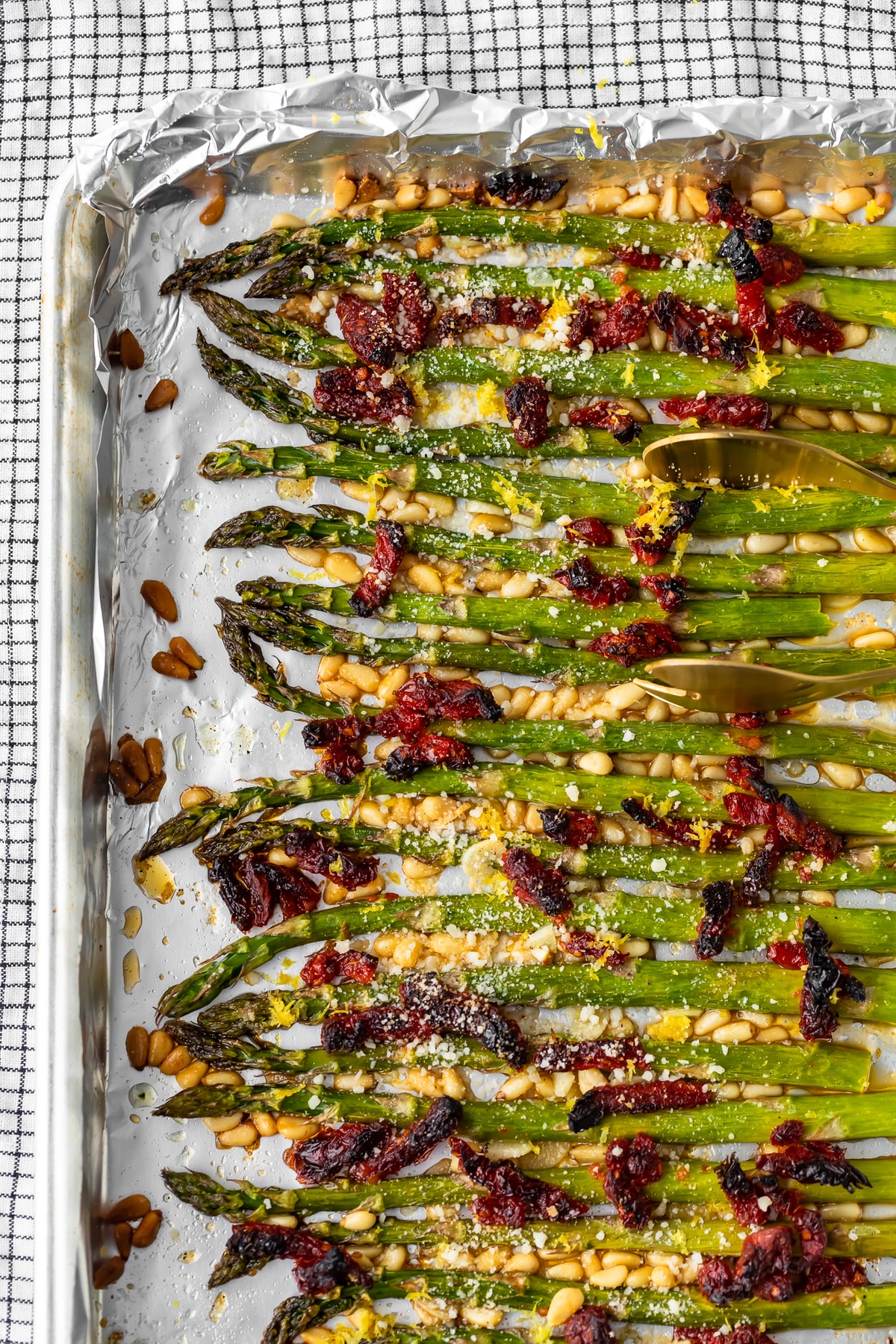 asparagus lined up on a baking sheet