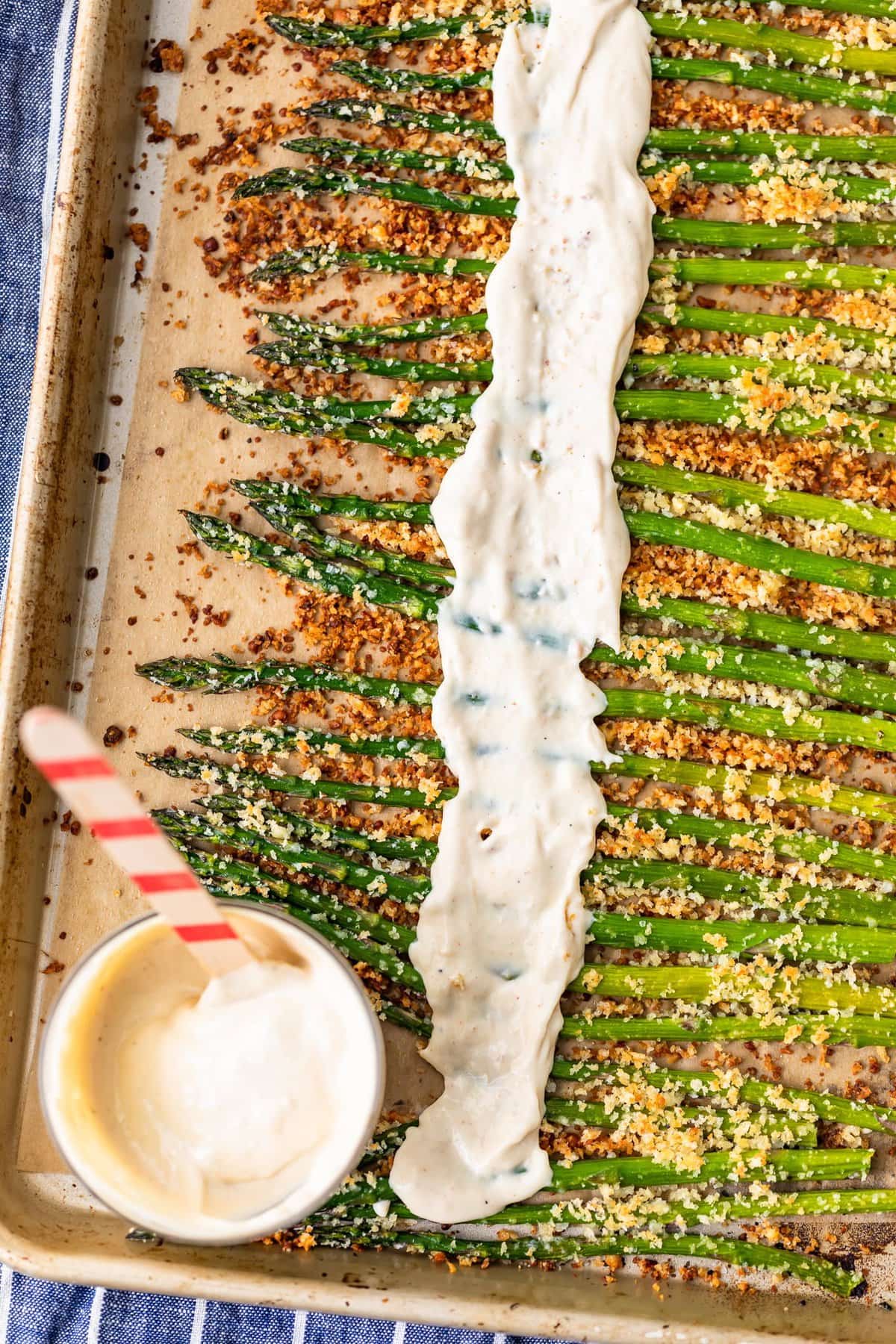 garlic aioli spread over roasted asparagus