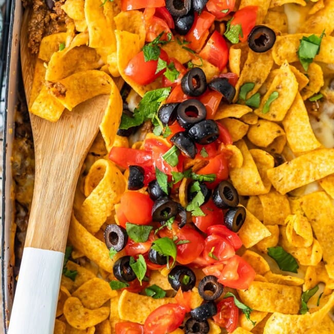 Frito Pie Casserole is an easy recipe with all the best Tex Mex flavors! Layer up the corn chips, beef, cheese, and more in a delicious dish that's perfect for weeknight dinners. Everyone will LOVE this Frito Pie recipe!