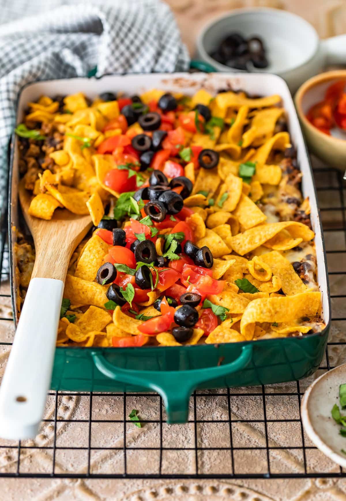 casserole dish filled with corn chips, beef, cheese, and more