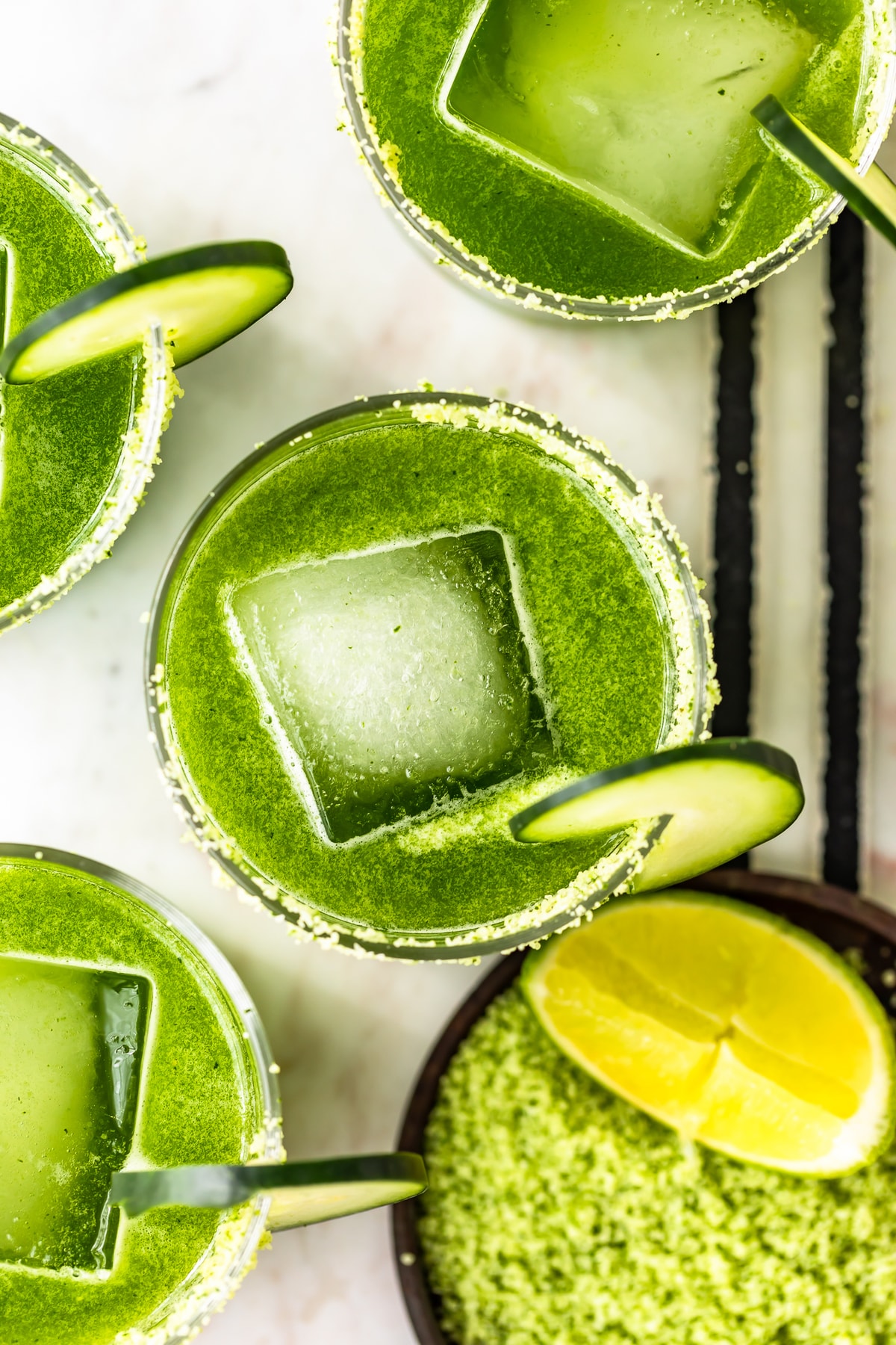 spicy cucumber margaritas overhead shot with cilantro salt