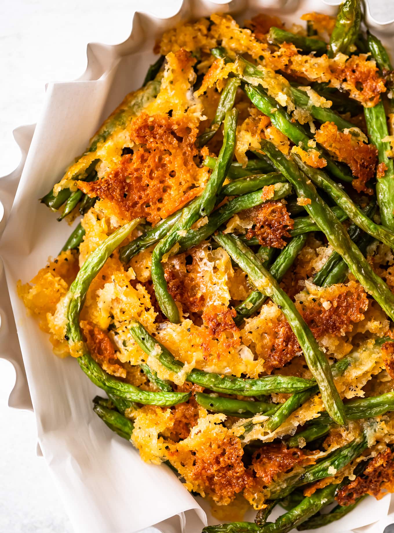 Close up of crispy baked green beans in a serving dish