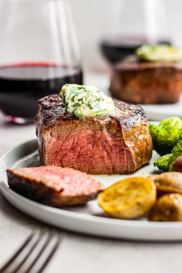 sliced steak with cilantro steak butter on top