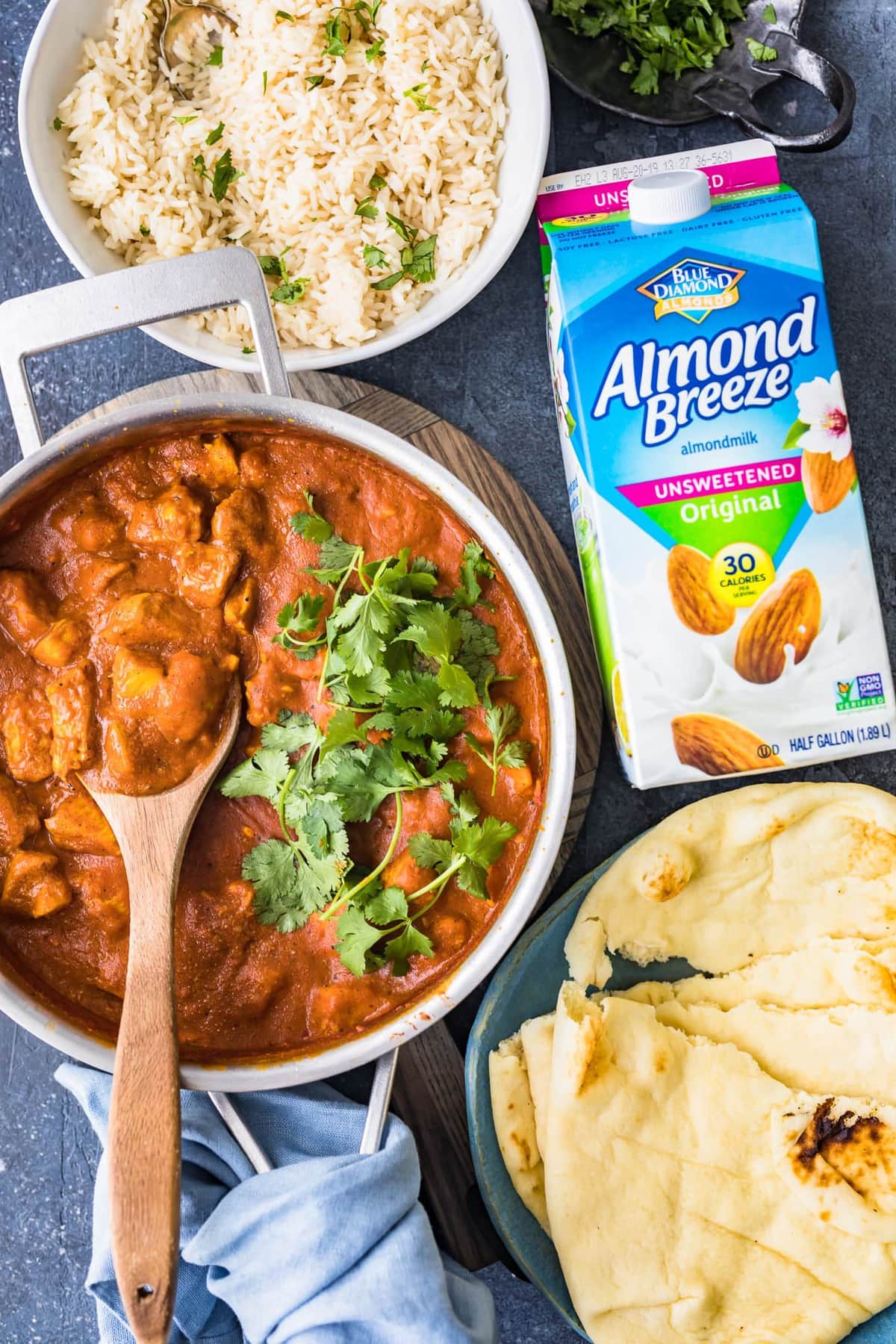 top view of curry, rice, bread, and almond milk