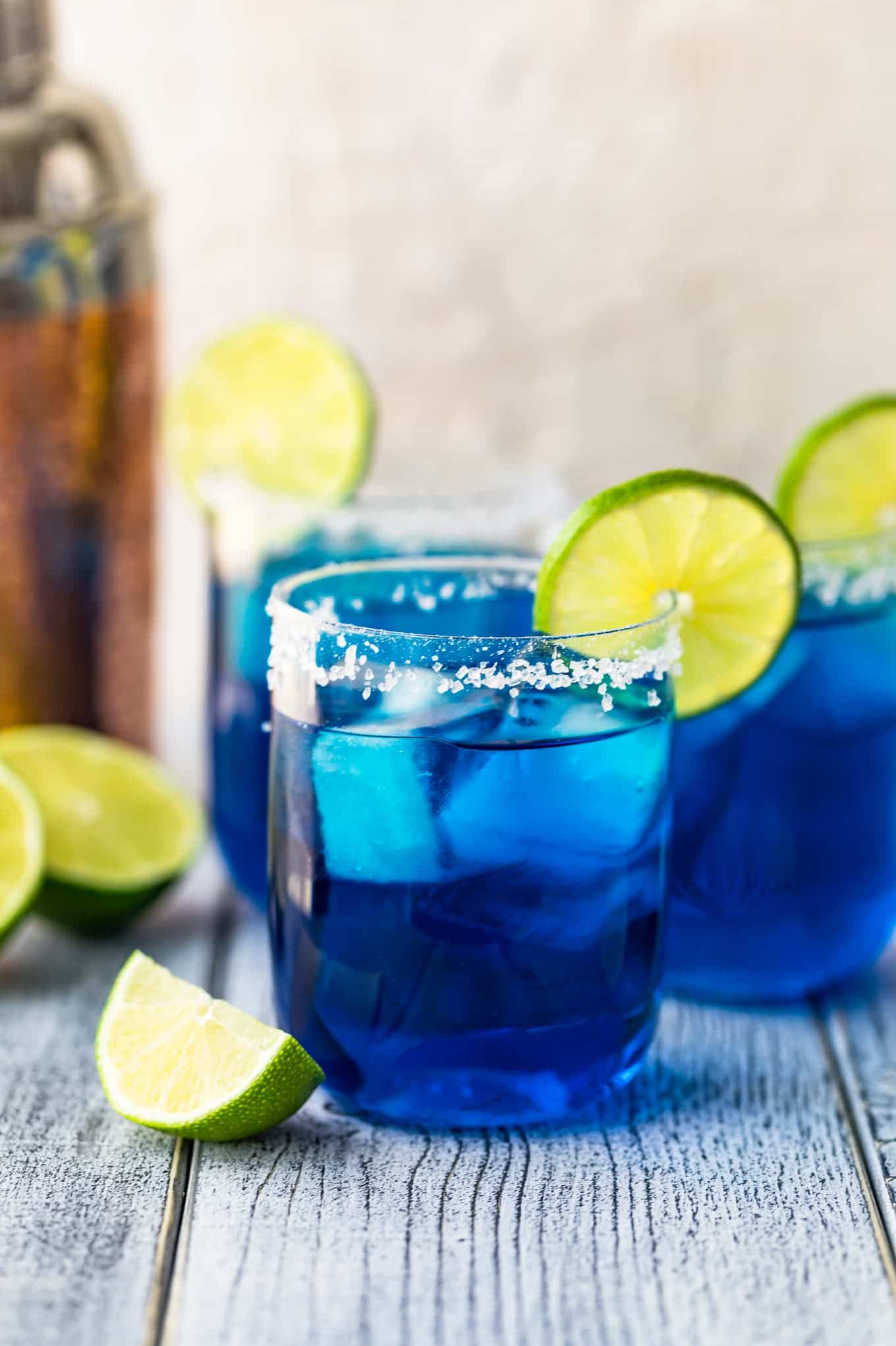 A salt rimmed blue margarita glass