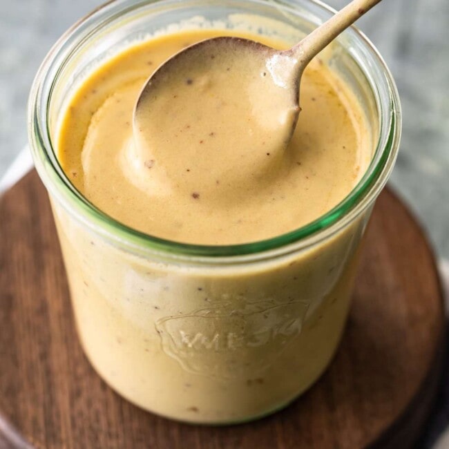 mustard cream sauce in a mason jar with spoon