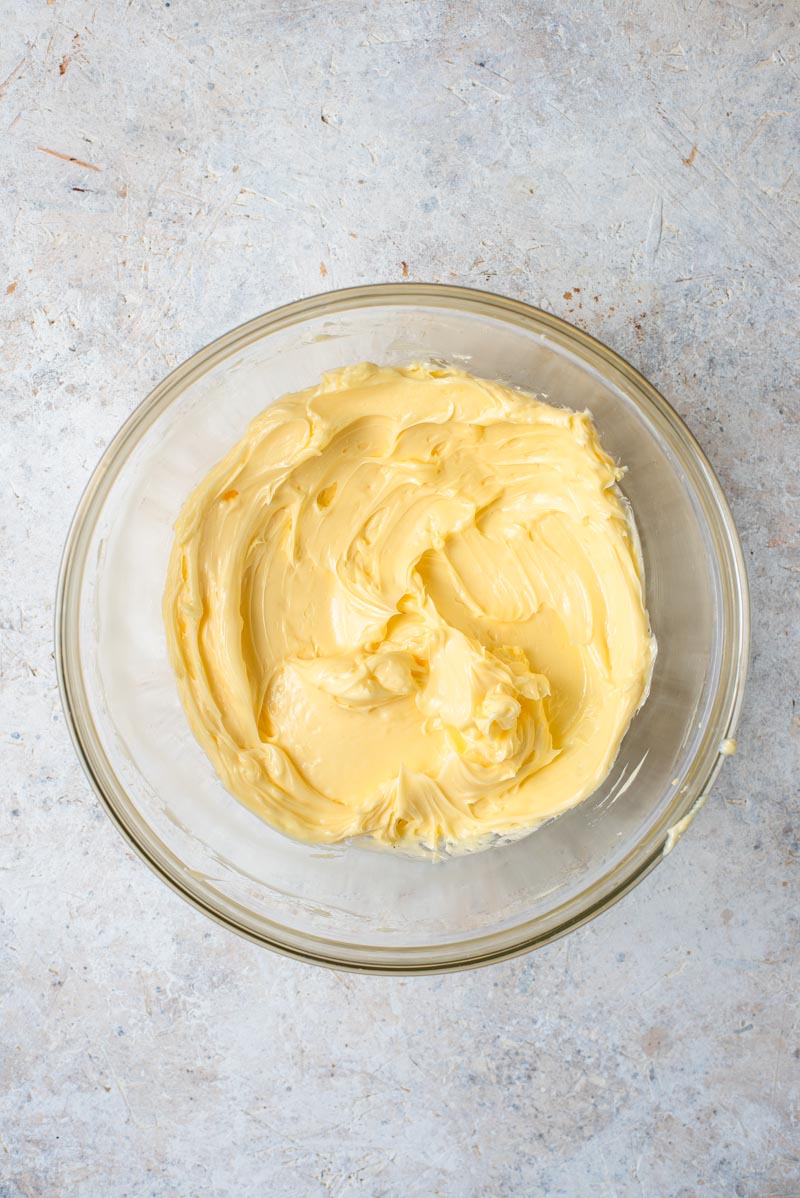 View of softened butter in a mixing bowl.