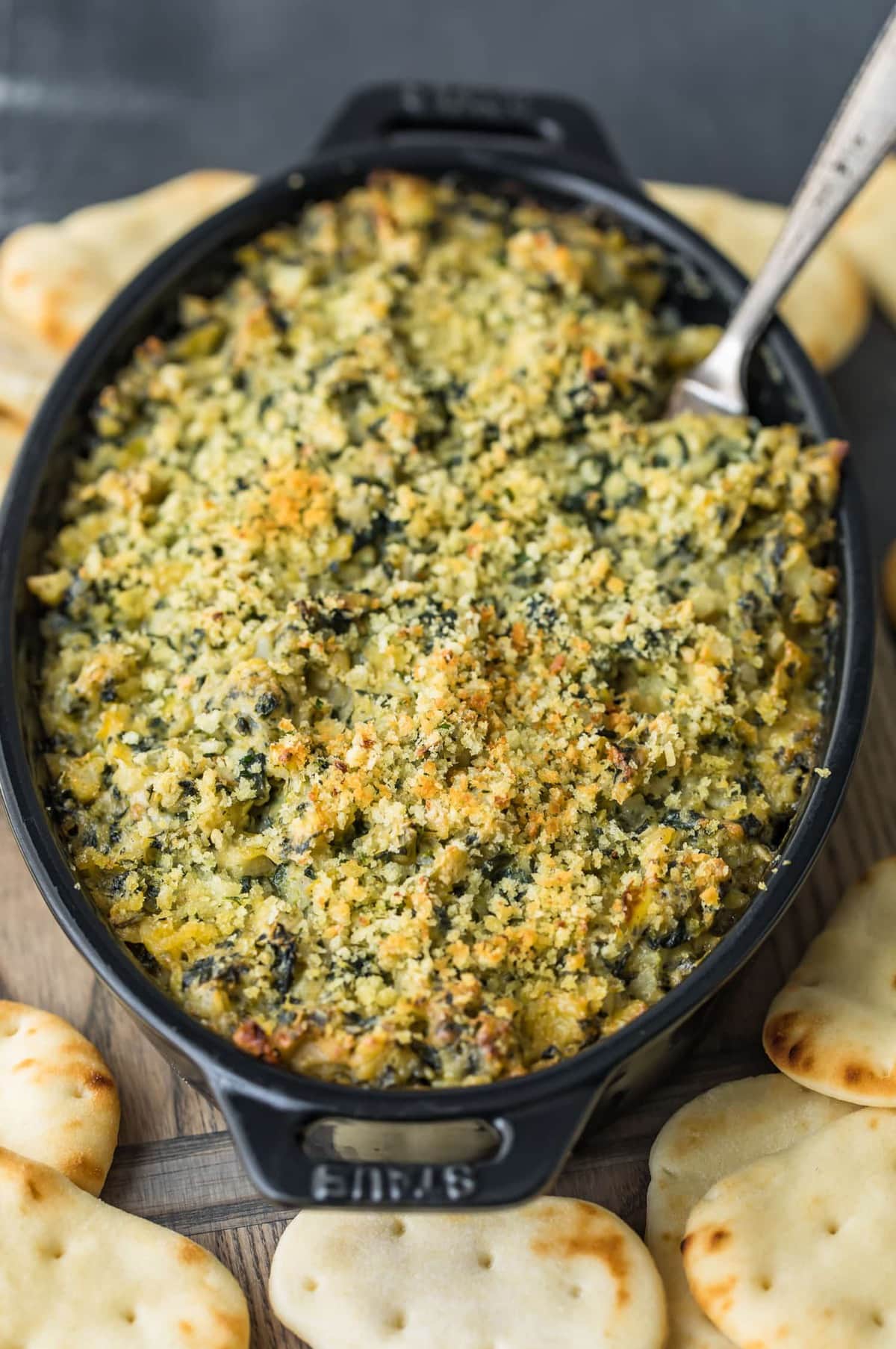 Baked Spinach Artichoke Dip with a fork in it