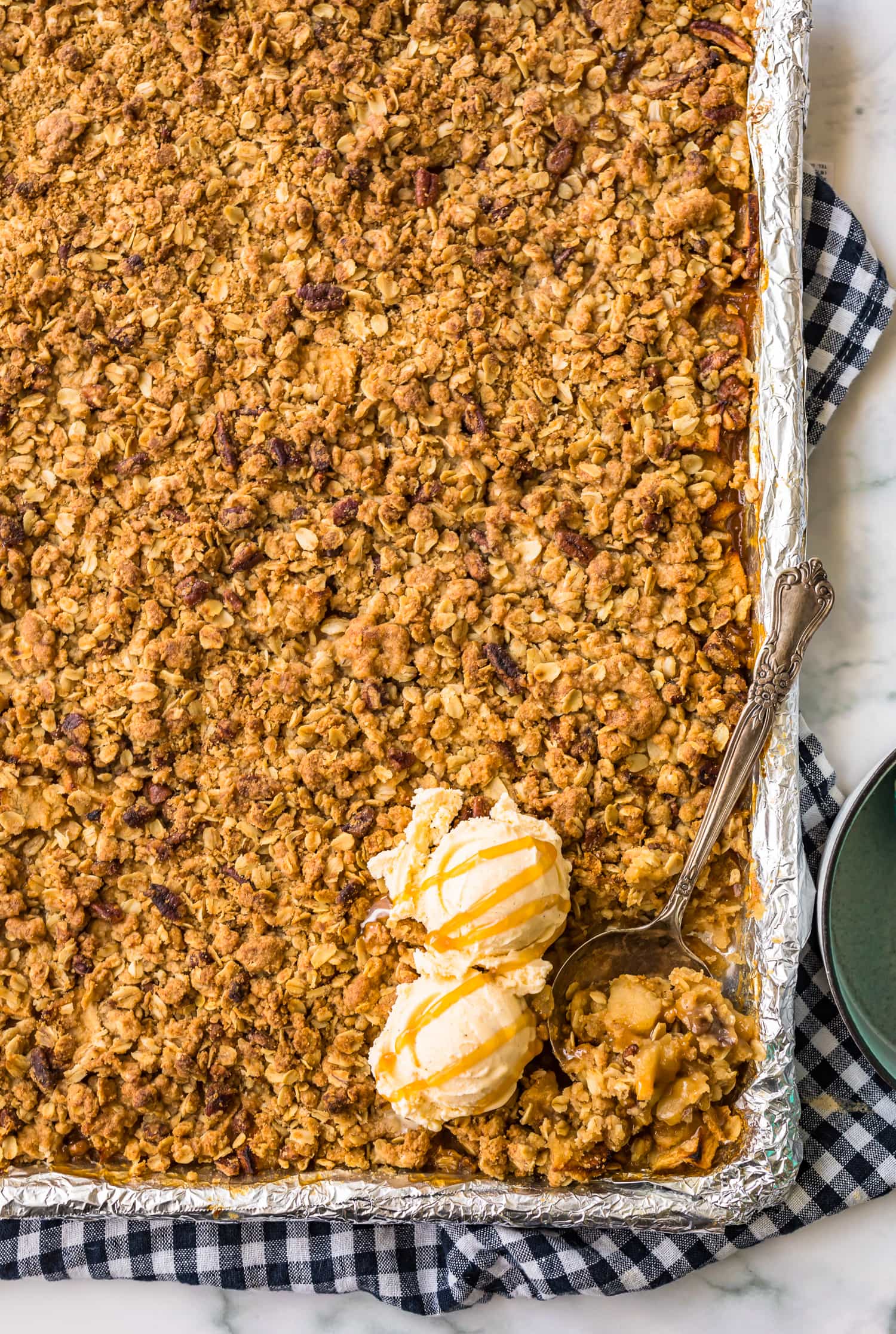 A sheet pan apple crisp with two scoops of ice cream