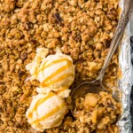 apple crisp in a sheet pan topped with ice cream