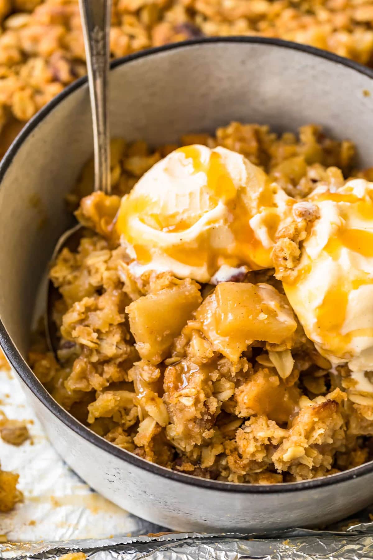 Close up of sheet pan apple crisp and ice cream in a bowl