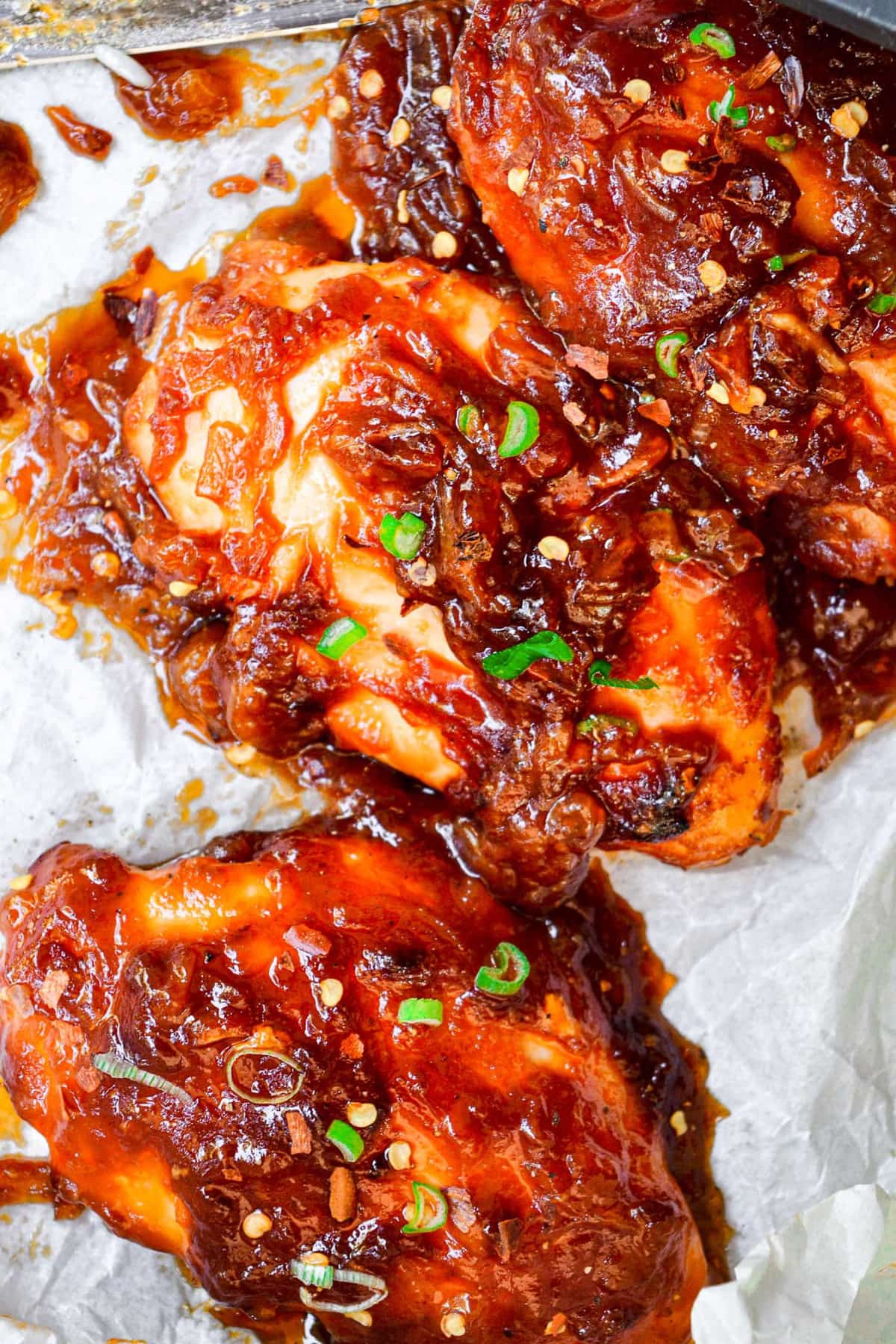 close up of chicken breasts smothered in sticky sauce.