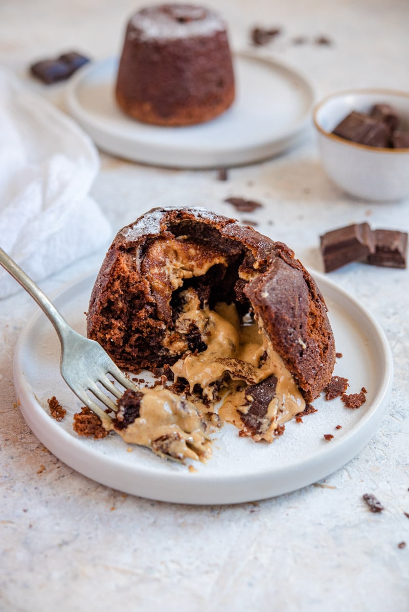 A close-up view of a chocolate lava cake with peanut butter oozing out