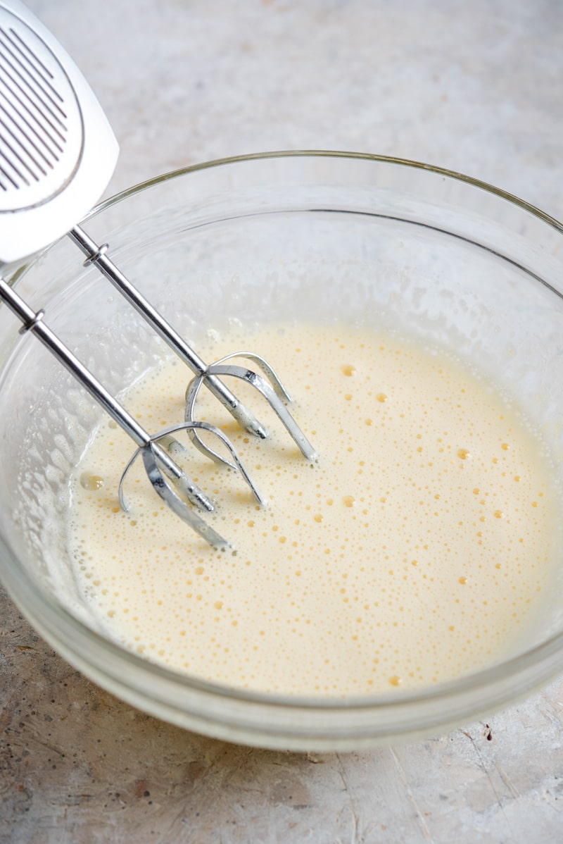 Eggs and sugar being mixed in a bowl