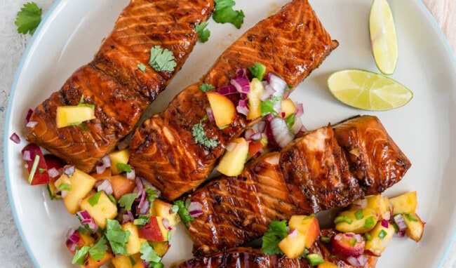 A plate of food on a table, with Salmon and Salsa