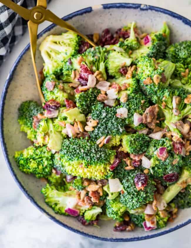 broccoli salad with bacon in a bowl and tongs