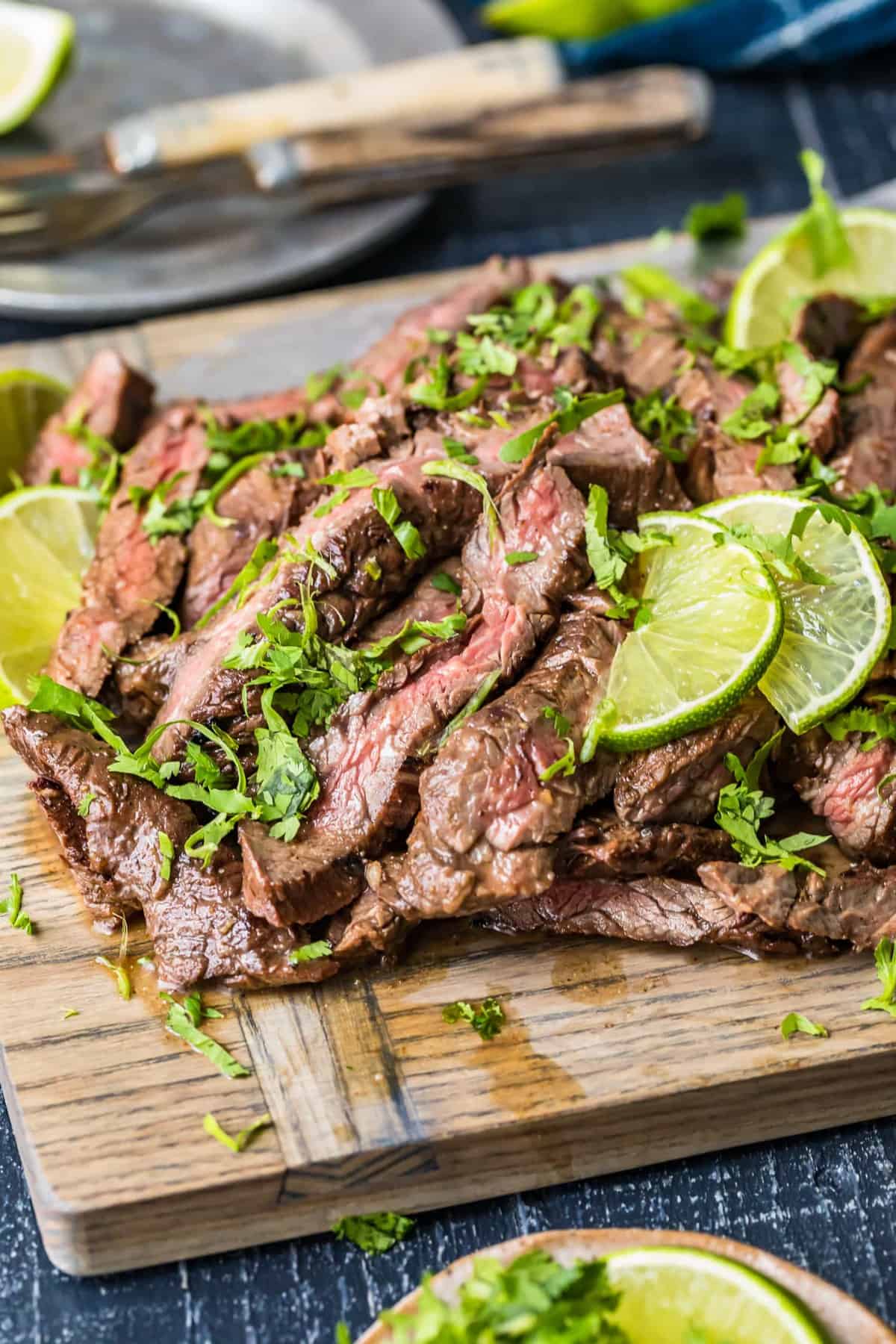 Carne Asada Steak sprinkled with fresh herbs and lime slices