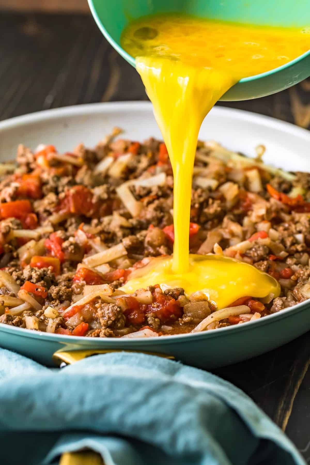 Egg being poured into the skillet