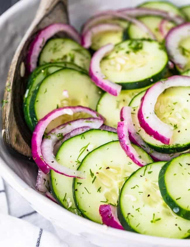 cucumber salad in a white bowl