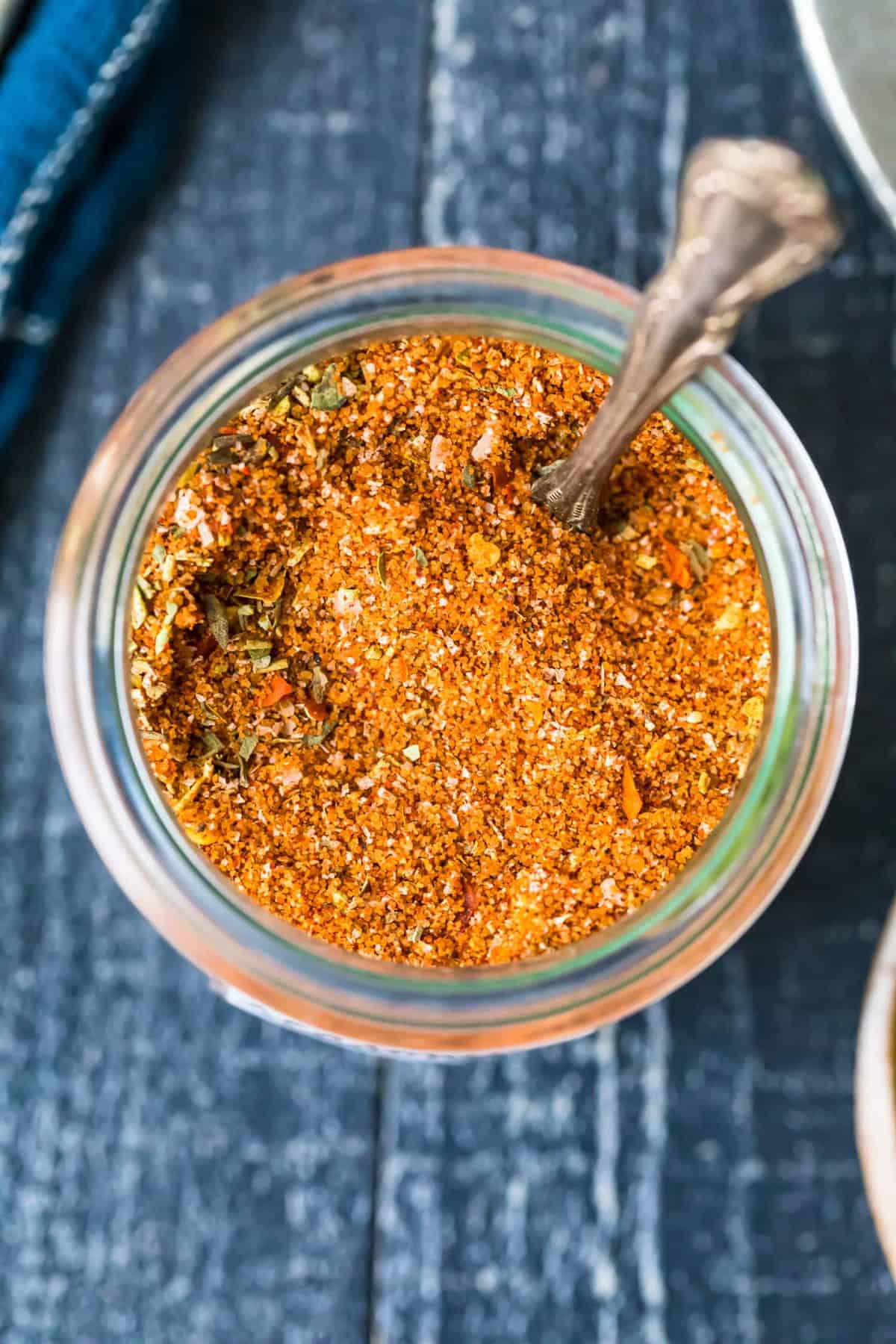 a jar of Homemade Fajita Seasoning with a spoon next to it.