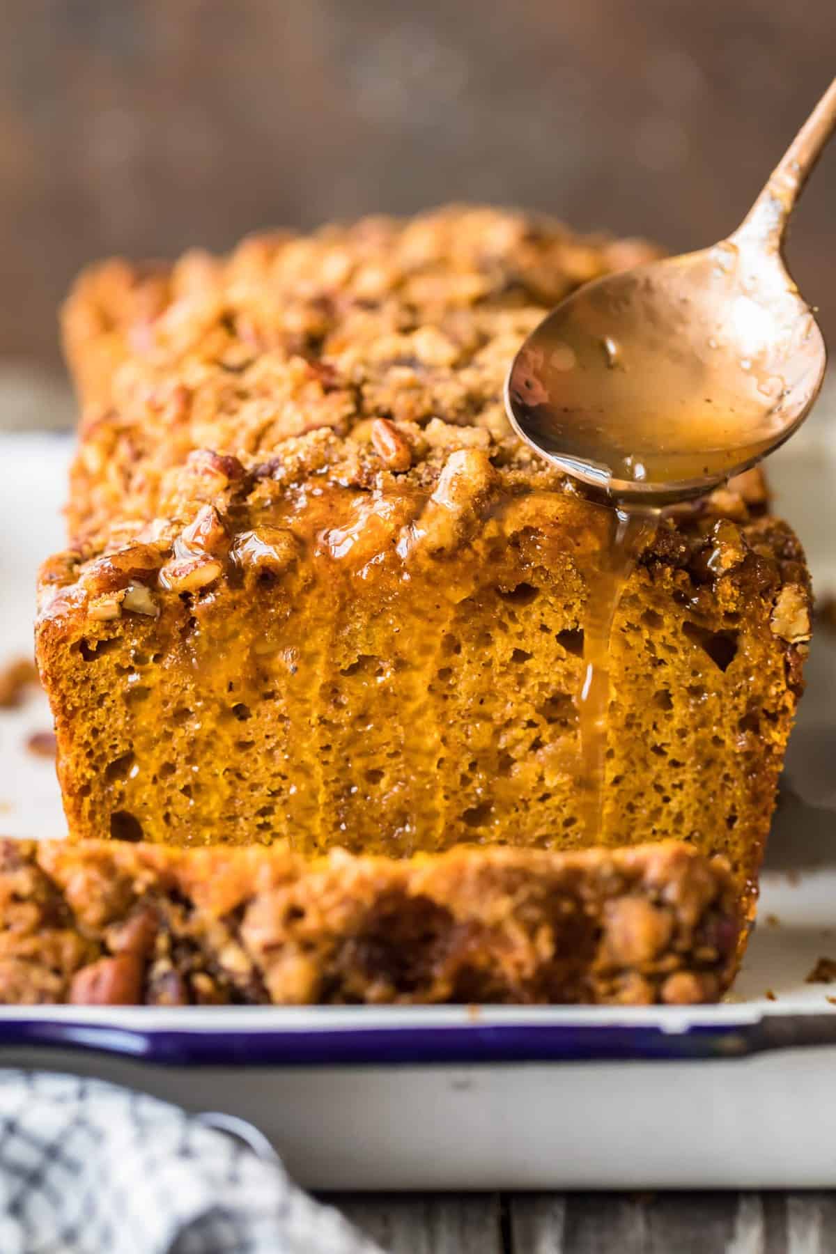 Apple Cider Sauce being spooned over the cake