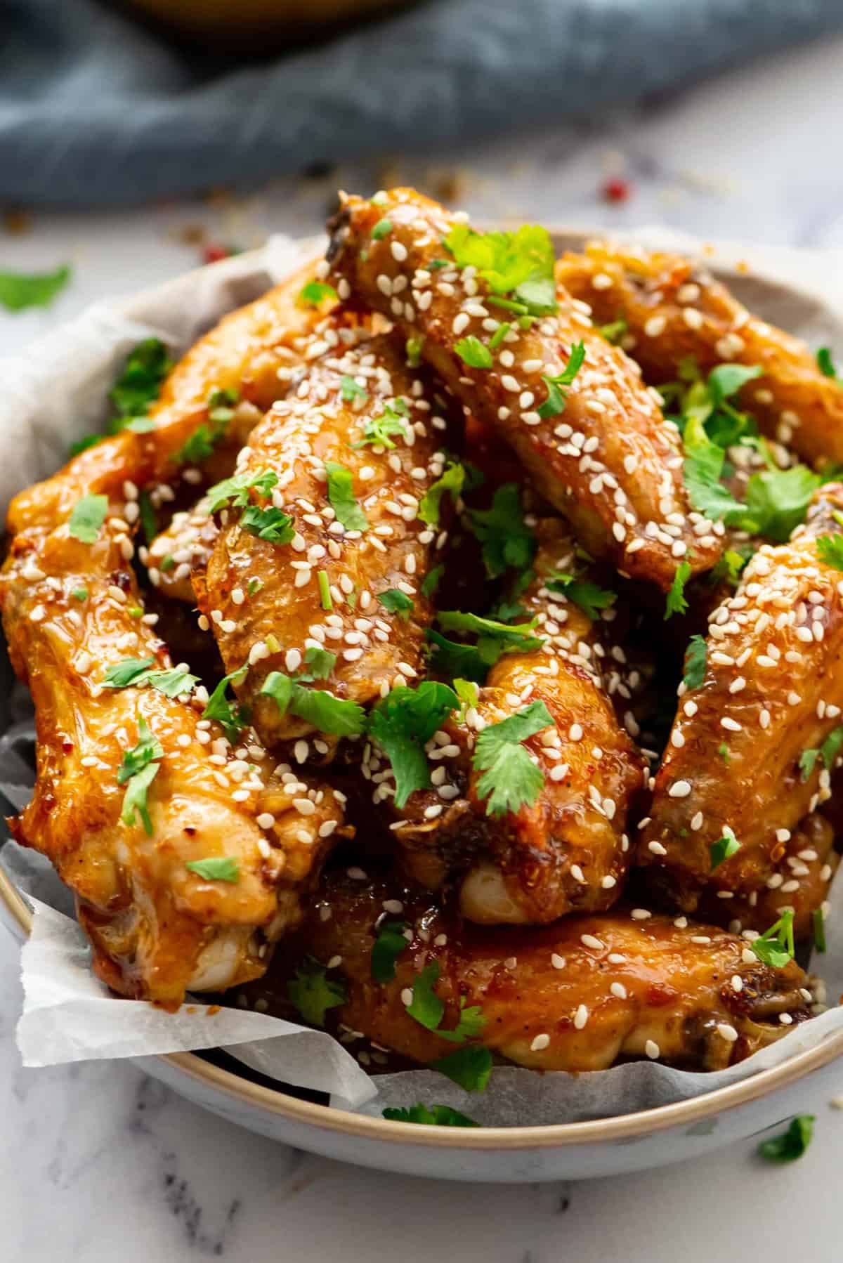 Honey Glazed Chicken Wings sprinkled with sesame seeds and fresh cilantro