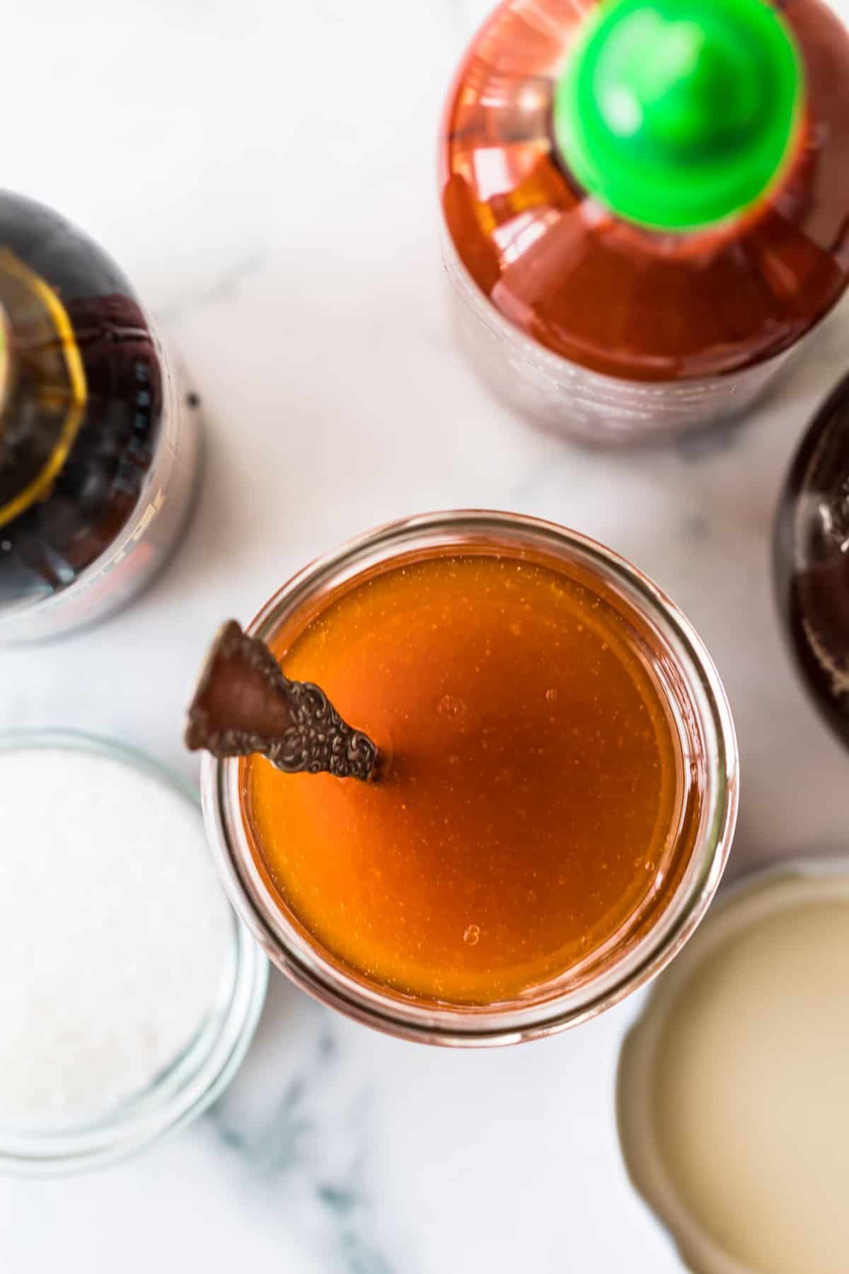 Spicy Sweet Salad Dressing in a jar with a spoon