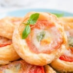 caprese tarts stacked on a plate