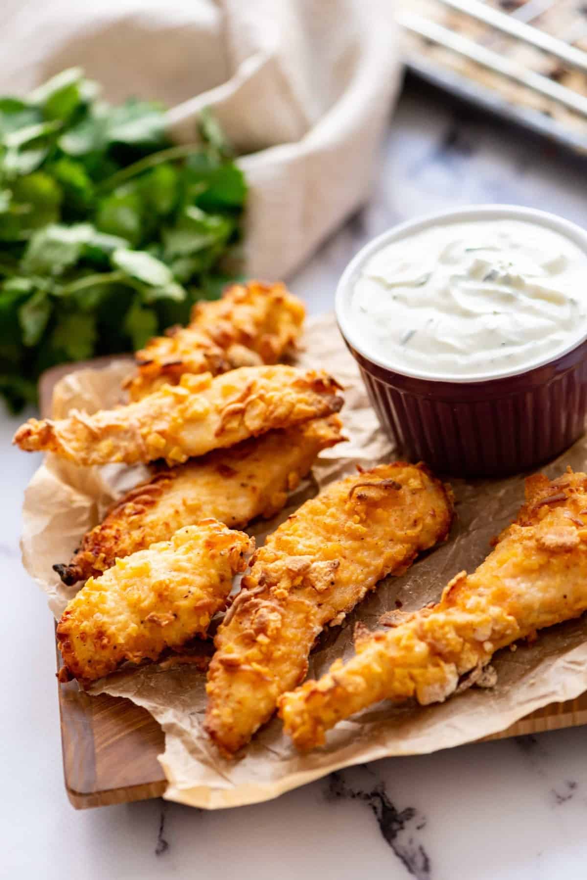 Chicken strips served on a board