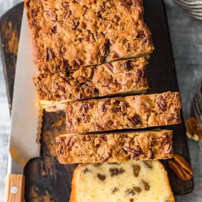 A slice of pecan bread on a cutting board.