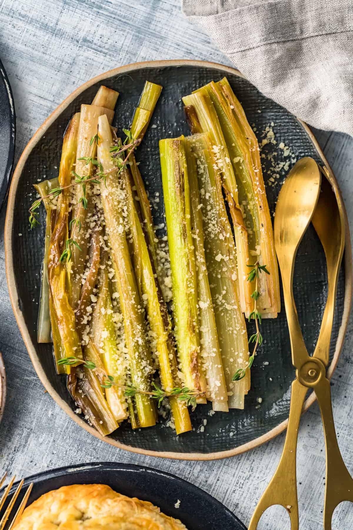 Sauteed Leeks with Parmesan on a black serving dish