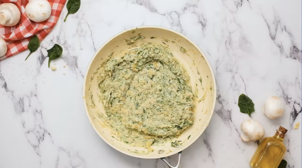 spinach artichoke filling in a pan.