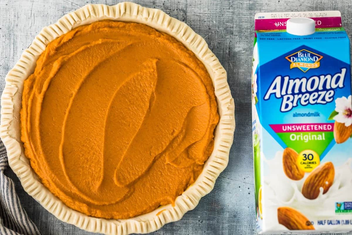 pumpkin pie next to almond breeze carton