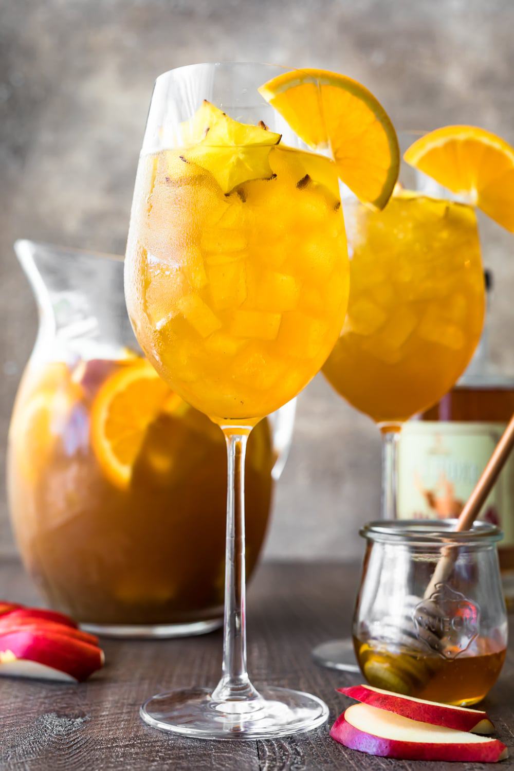 Two glasses of sangria in front of a pitcher