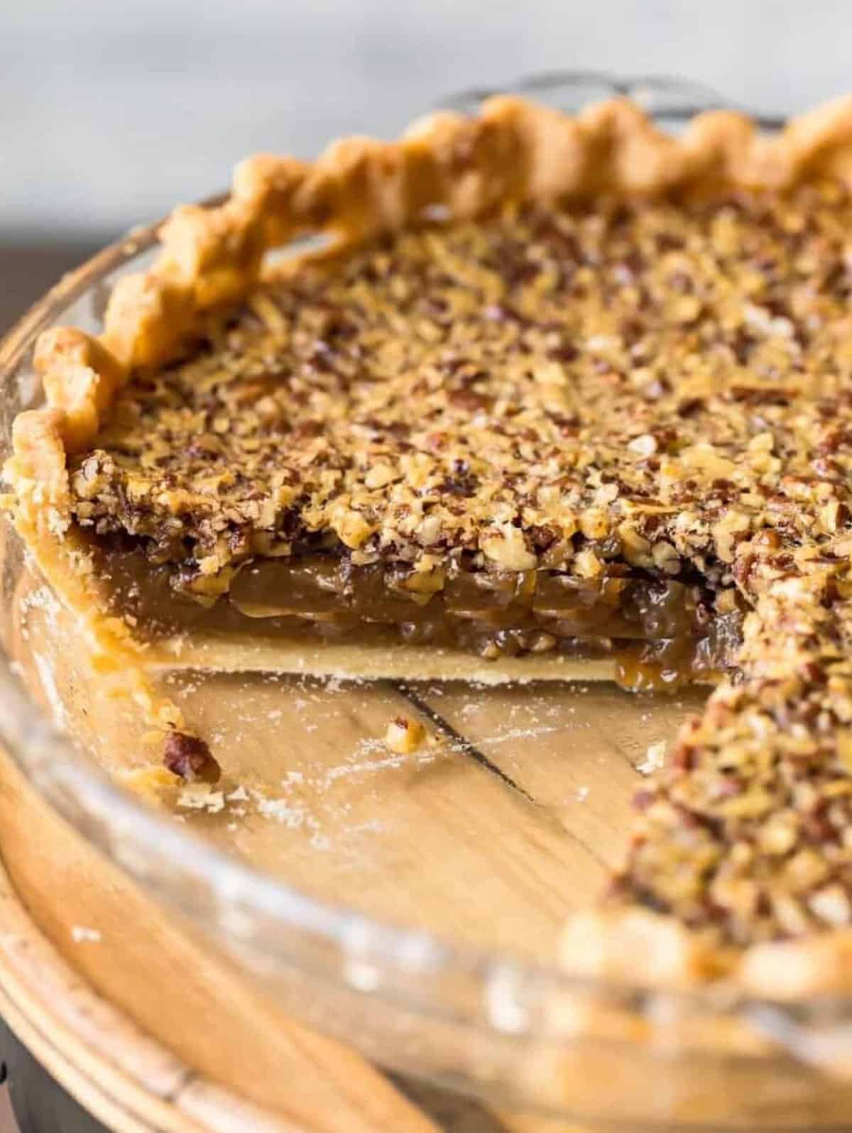 A Classic Pecan Pie with a slice taken out.