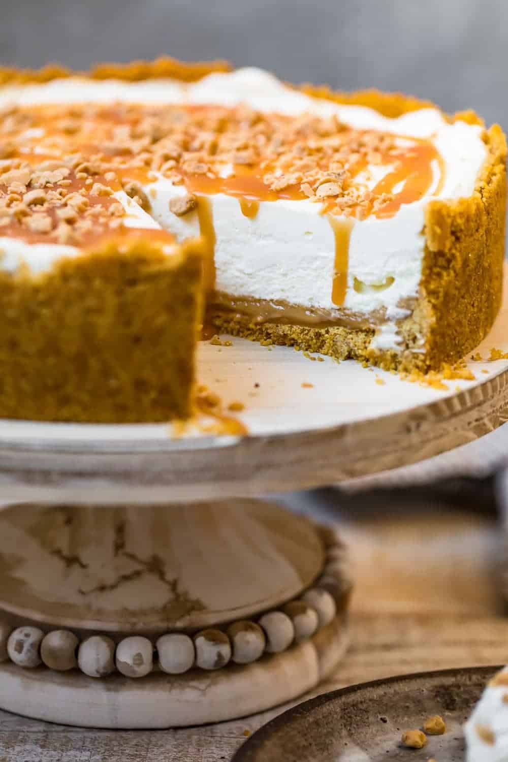 Salted Caramel No Bake Cheesecake on a cake stand