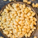 candied corn puff snack mix in bowl