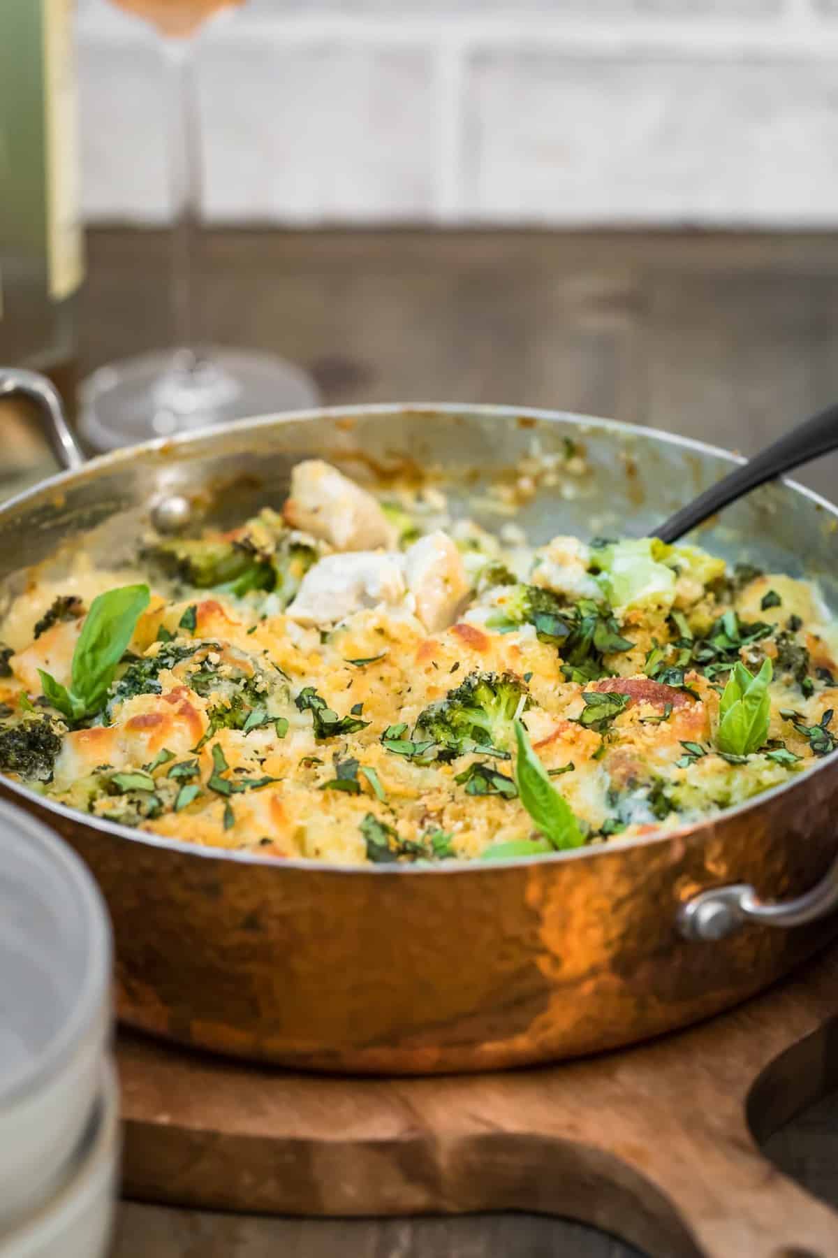 Side view of creamy Chicken Alfredo Gnocchi Bake in silver pan